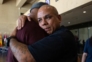 Aaron Michaels hugs John Lucio after a press conference regarding the future of Lucio's mother on death row, Melissa Lucio, at Dallas City Hall on April 8, 2022. Michaels is the husband of Kimberly McCarthy, who was executed on death row in 2013.